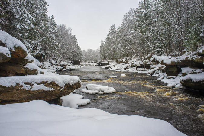 A river flowing throw snowy banks