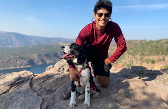A photo of Ben Vasquez next to a dog at Flaming Gorge, Utah.